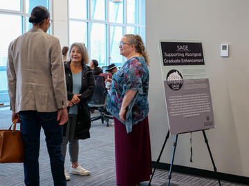 Photo of event attendees and SAGE sign